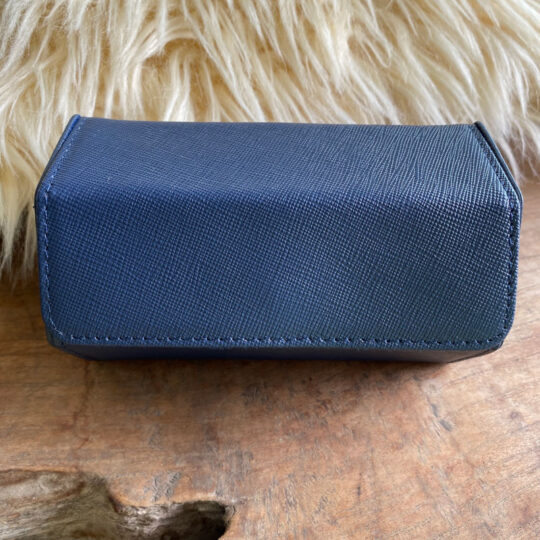 blue genuine leather hexagon shaped watch travel case. Blue velvet inside with sliding M-shape watch cushions.